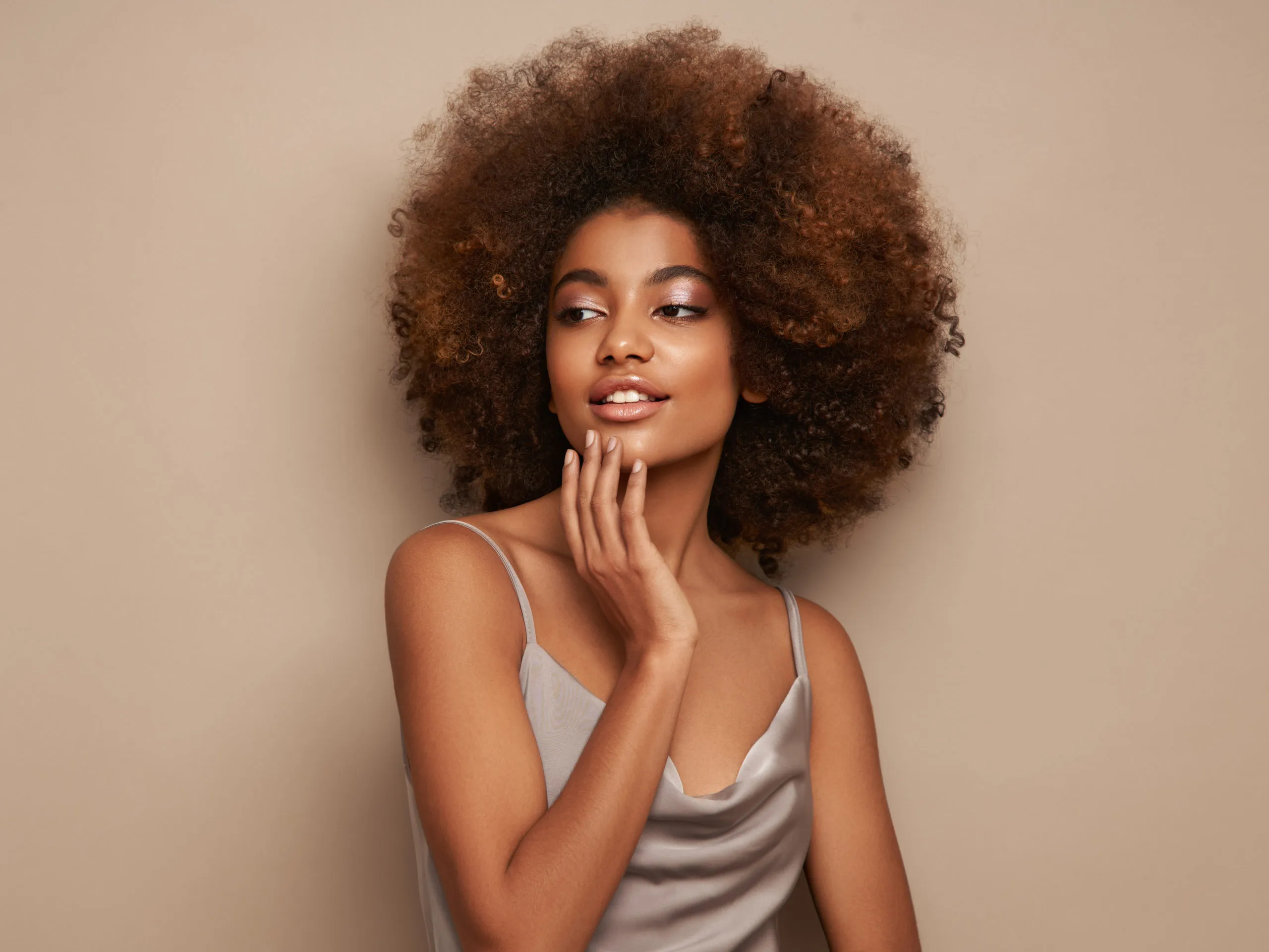 African Woman Touching Hand on Chin | The Skin Refinery in Fayetteville, TN